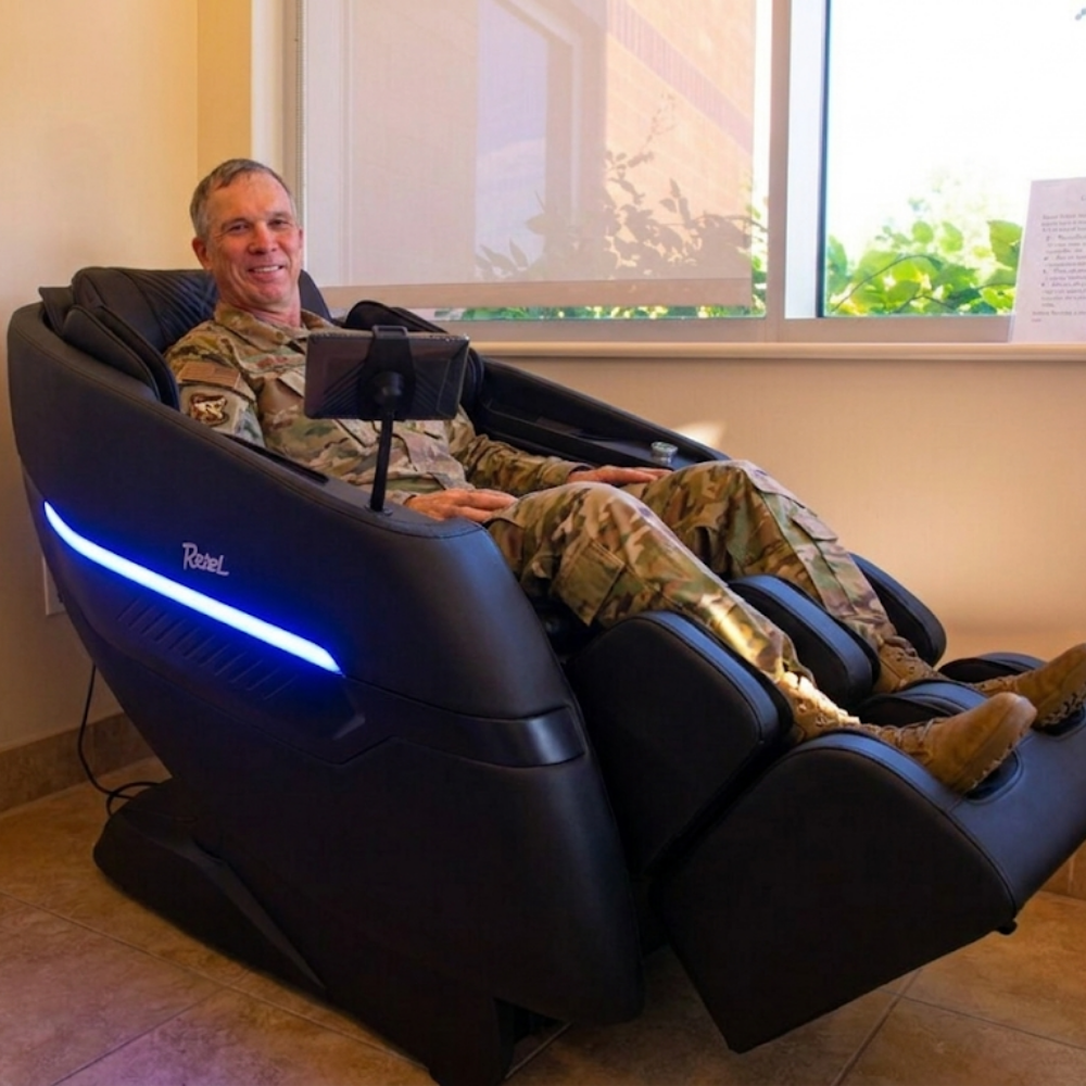 A smiling US military officer experiencing the physical benefits and back pain relief of the Floridian Brand Rebel 4D massage chair.