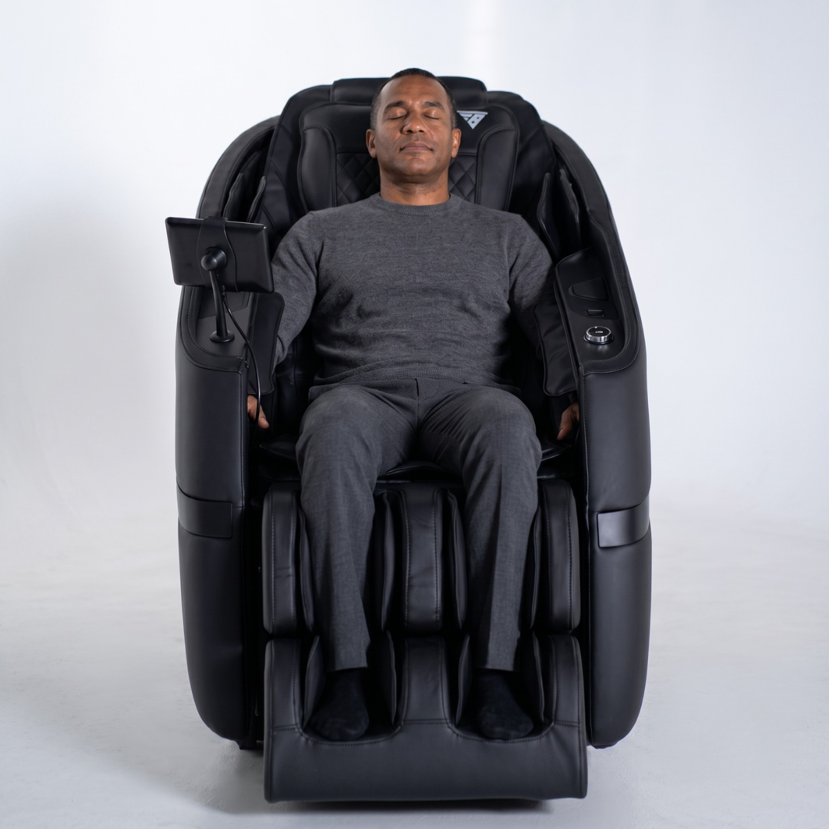 Rebel 4D massage chair shown in a cinematic studio with core technology and comfort features