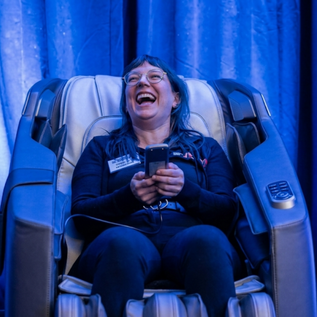 Massage chair wellness lounge arranged for attendees at a corporate conference.