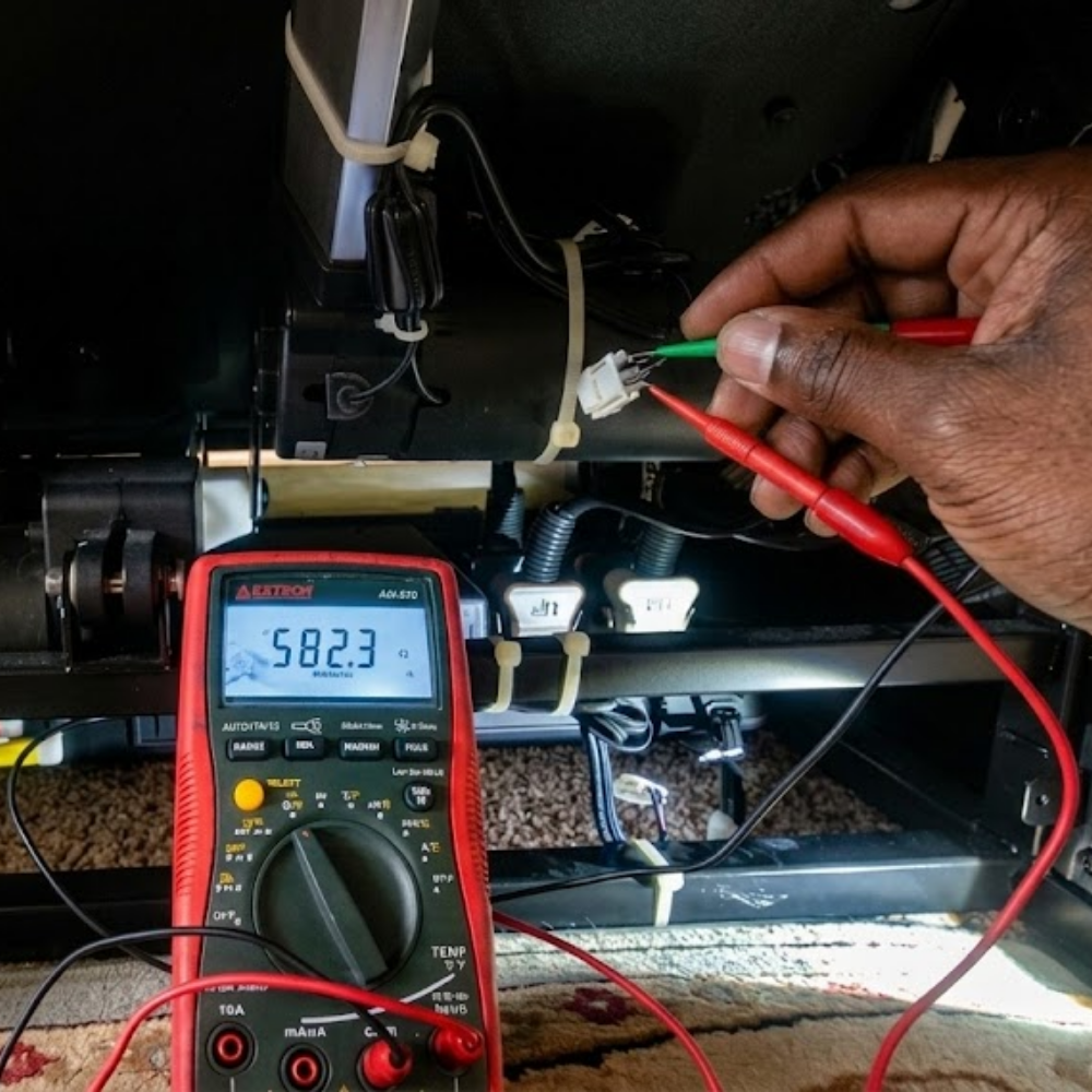 Technician documenting massage chair repair issues during in-home diagnostic service